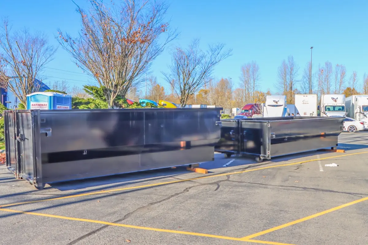 Professional dumpster rental service with roll-off container on residential driveway in Lochbuie